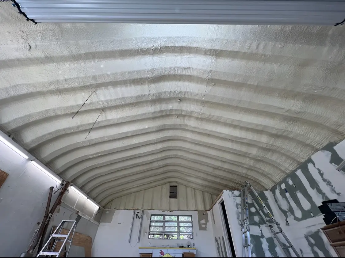 Spray polyurethane foam applied to the underside of a metal roof deck in South Park